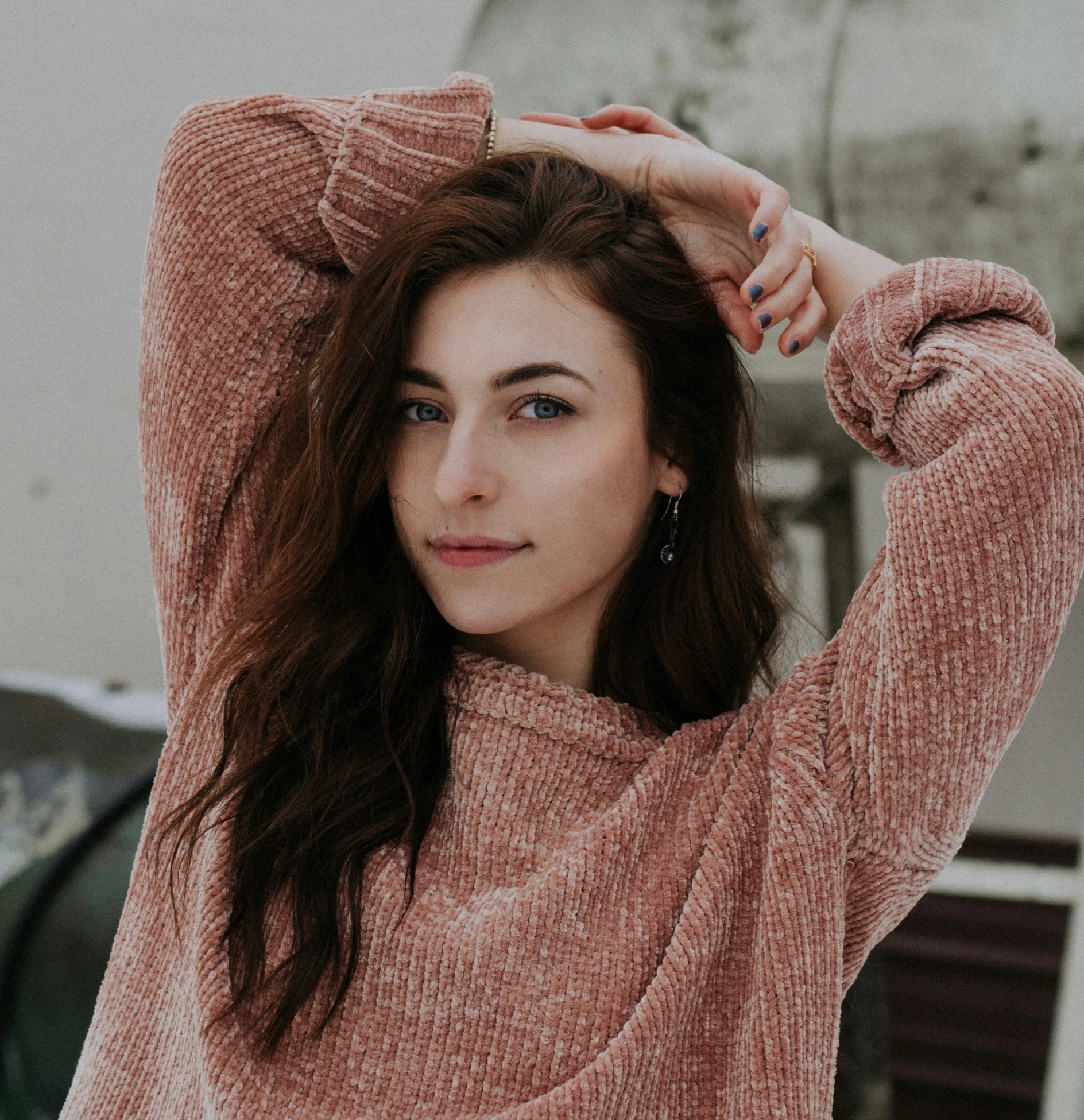 woman in a pink top poses for the camera