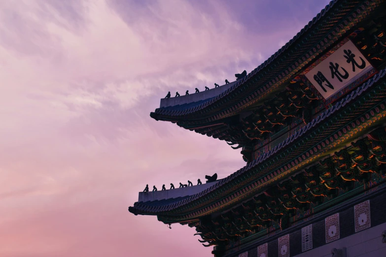 purple sky behind a tall pagoda with the name tokyo written on it