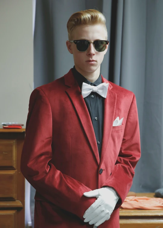 young adult man in formal suit with sun glasses