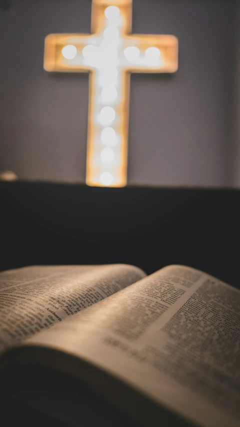 a cross with lights shining down on it