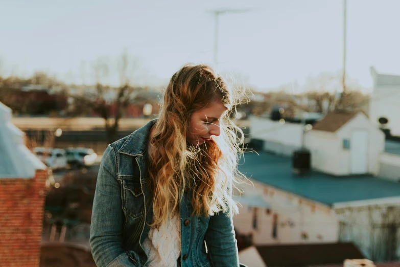 a young woman looking at her phone in a town