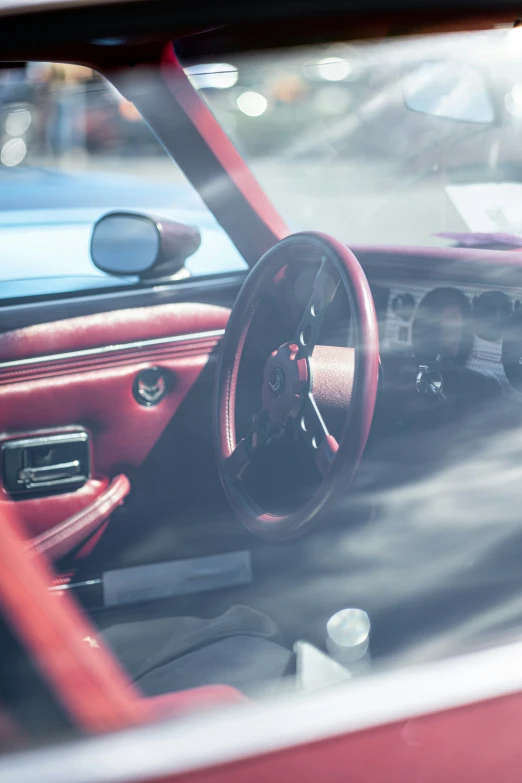 a red car sitting in a parking lot