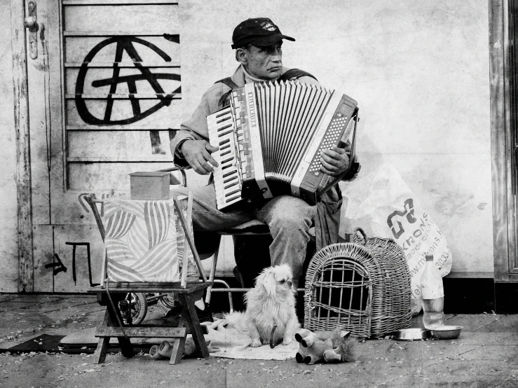 a man that is sitting down with an accordion