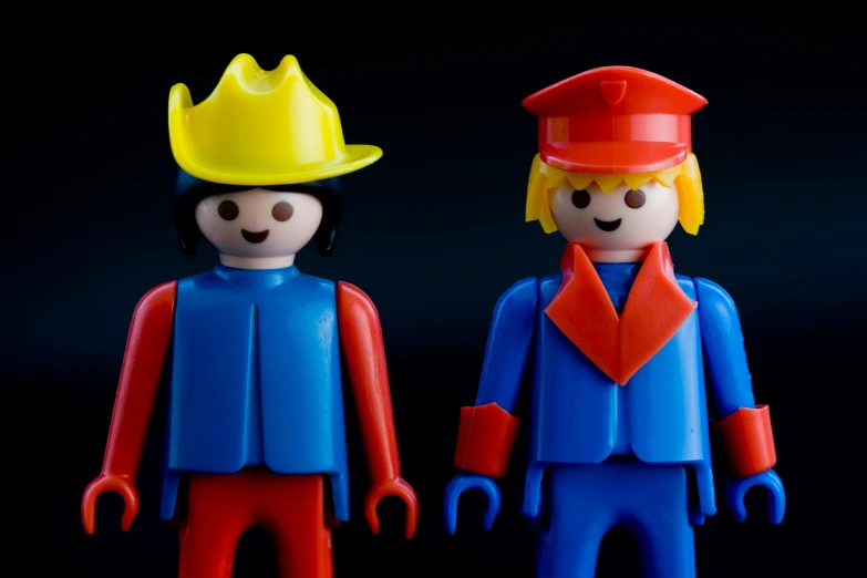 two toy figures made from legos wearing hardhats