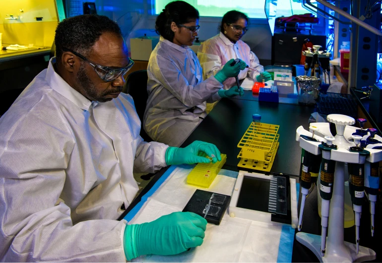 people working in an experiment lab with samples and equipment