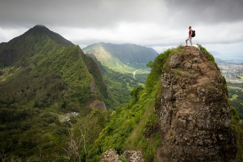 a person with a backpack on top of a hill