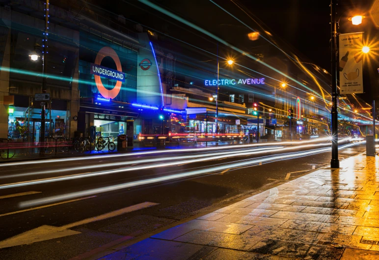 a street scene with focus on the store fronts and illuminated traffic