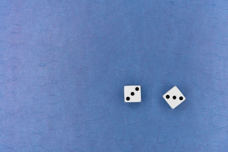 two white dices laying on top of each other