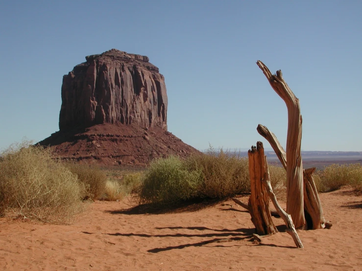 the tall, red rock formation of monument in desert land