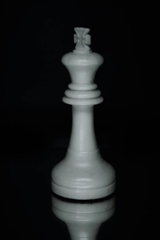 a white chess piece with the chess pieces facing towards the viewer