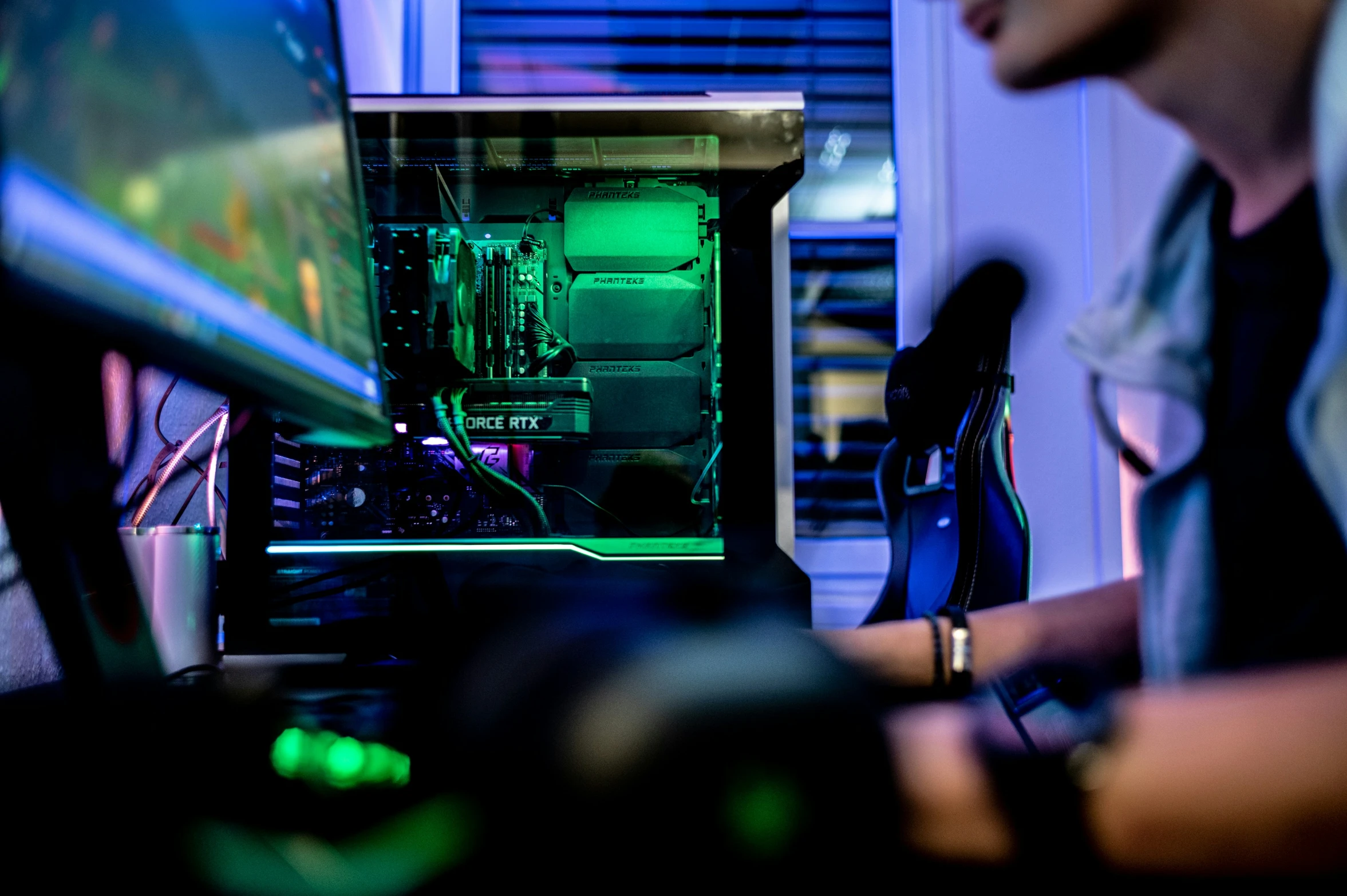 person working on a computer in front of a monitor