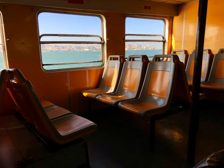 two seats on a ship by the windows