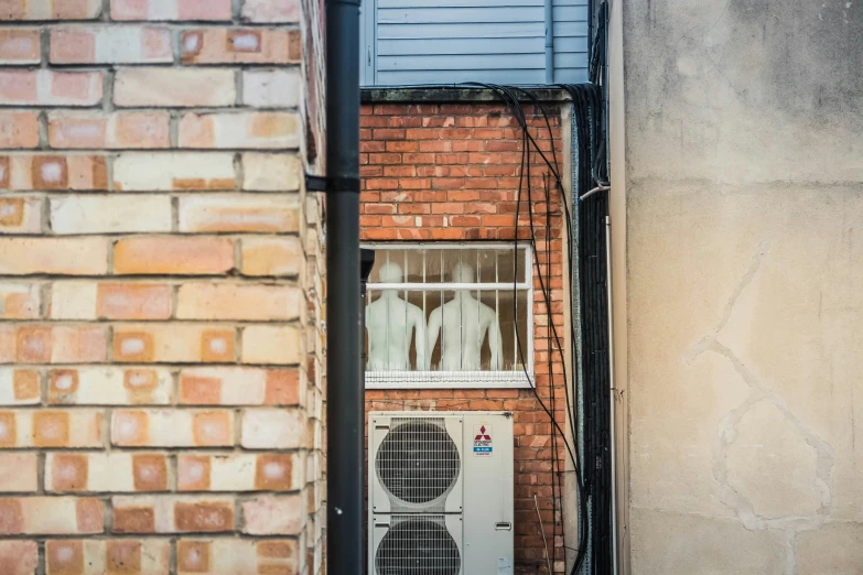 a building with a ventilator in front of it and some brick building