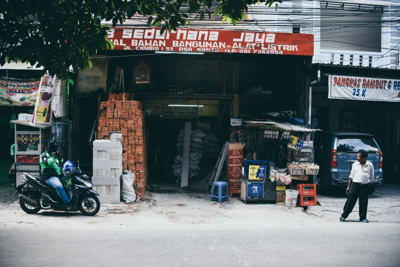 a man walking down the street in front of a building