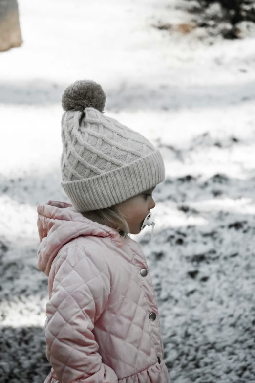 a little girl that is wearing a coat