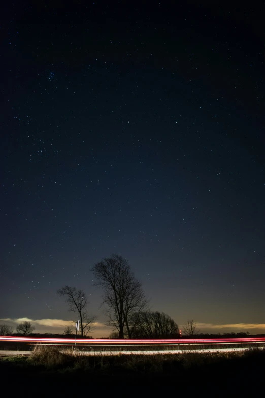 the road is in front of the trees with long exposure