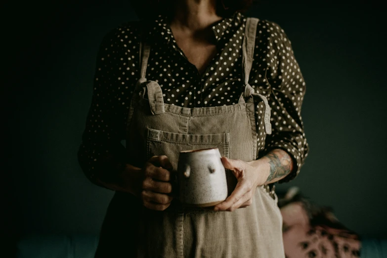 a woman holding a cup that she has put in her hand