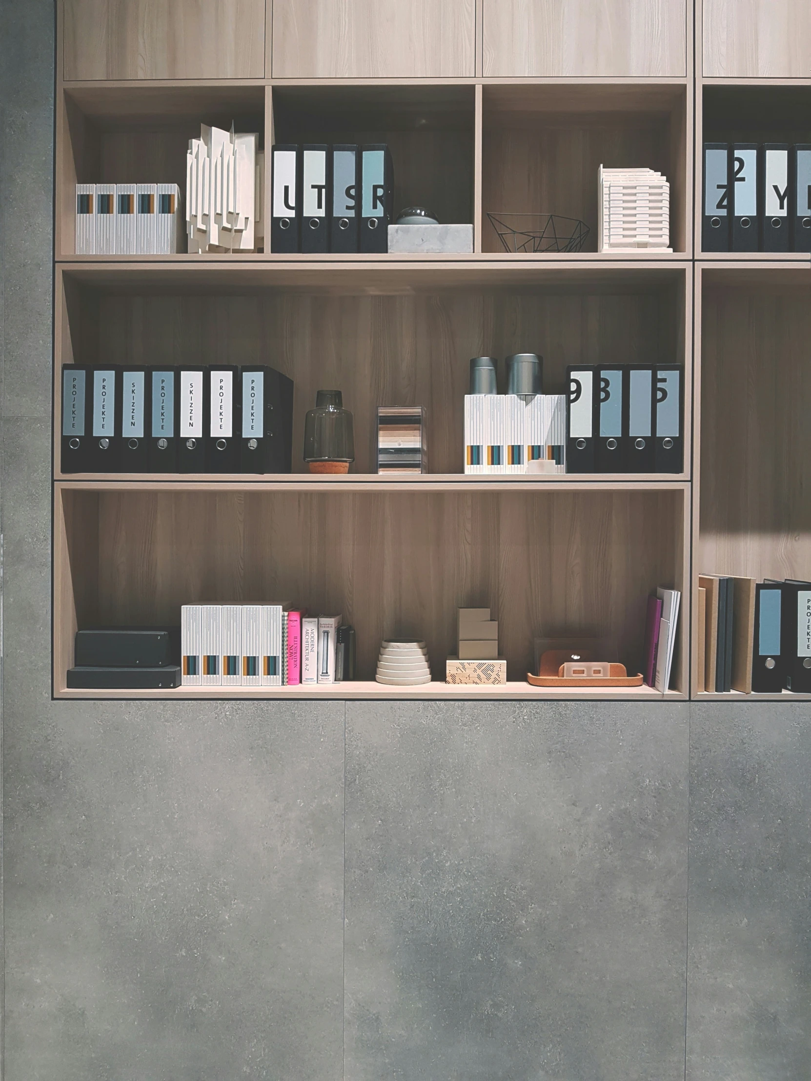 a gray shelf with many files and files on it