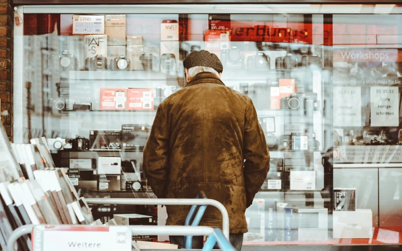 a man is looking at his store with a glass