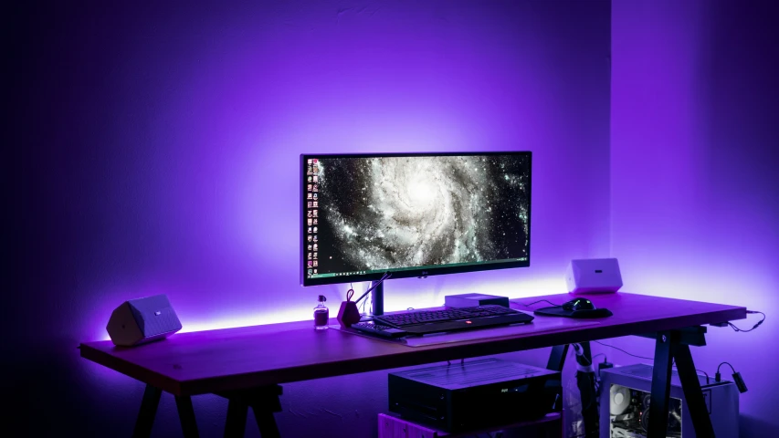 a computer monitor that is turned on with purple light