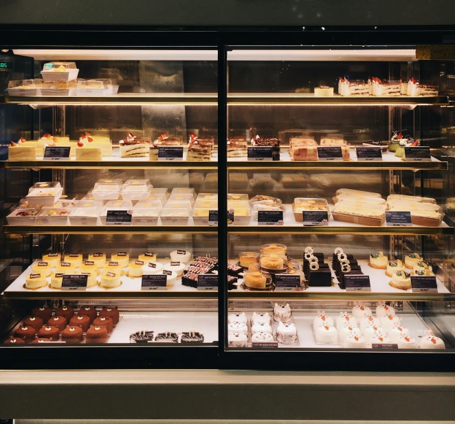 bakery case display with multiple shelves full of pastries