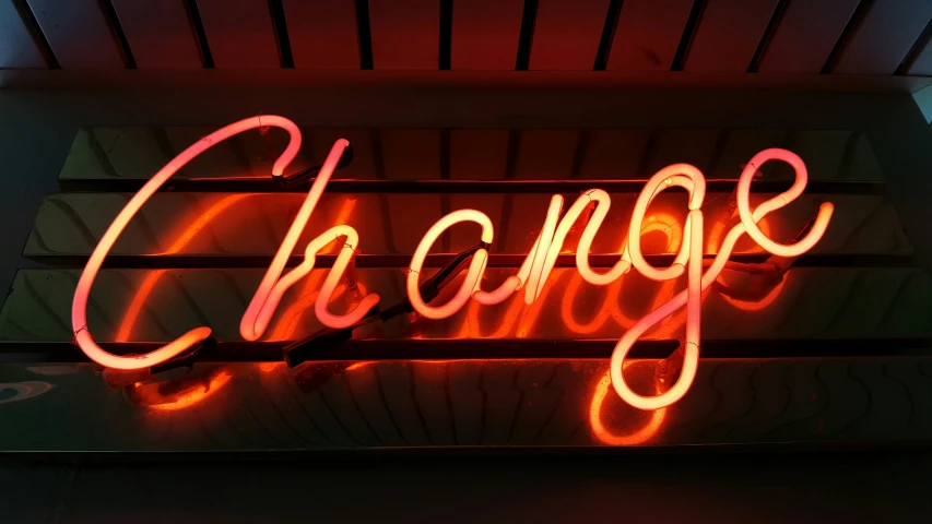 a sign that says change is made with neon lights