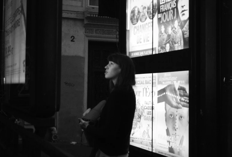 a woman that is standing up outside of a store