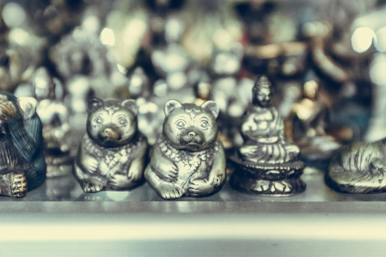 some silver and black little animals sitting on a table