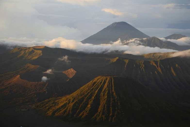 a group of hills with some very steep peaks covered by clouds