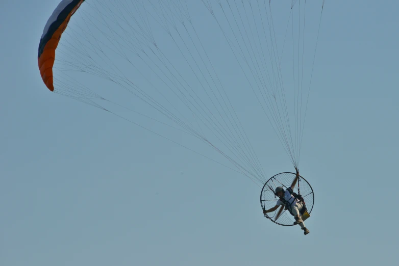 a man flying in the sky over an object in front of him