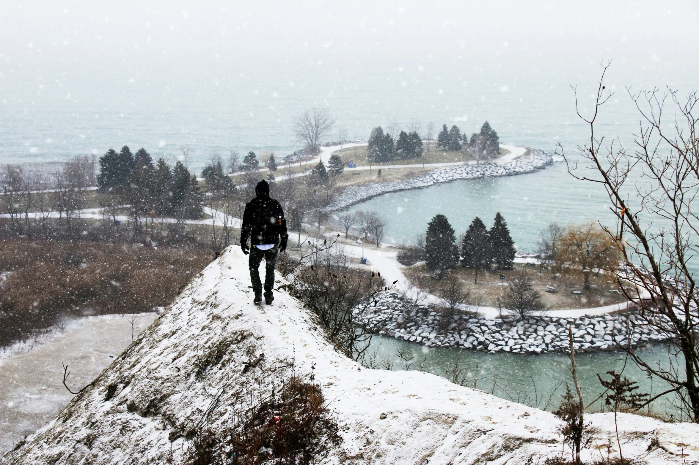 a person standing on top of a snow covered hill