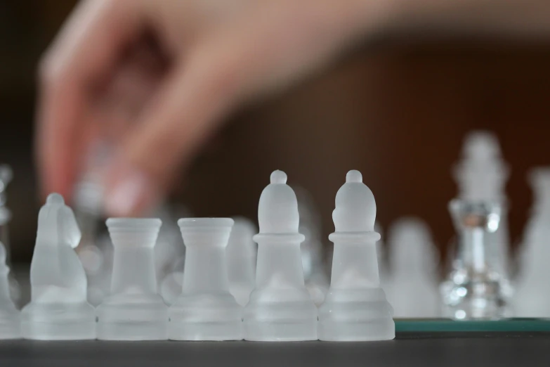 a man moves through the plastic chess set
