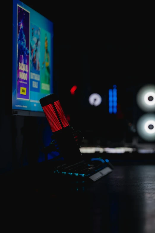 a lit up television and computer monitor with black background