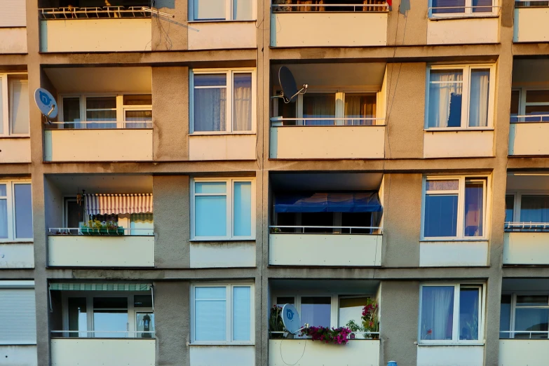 windows and balconies of a beige apartment building