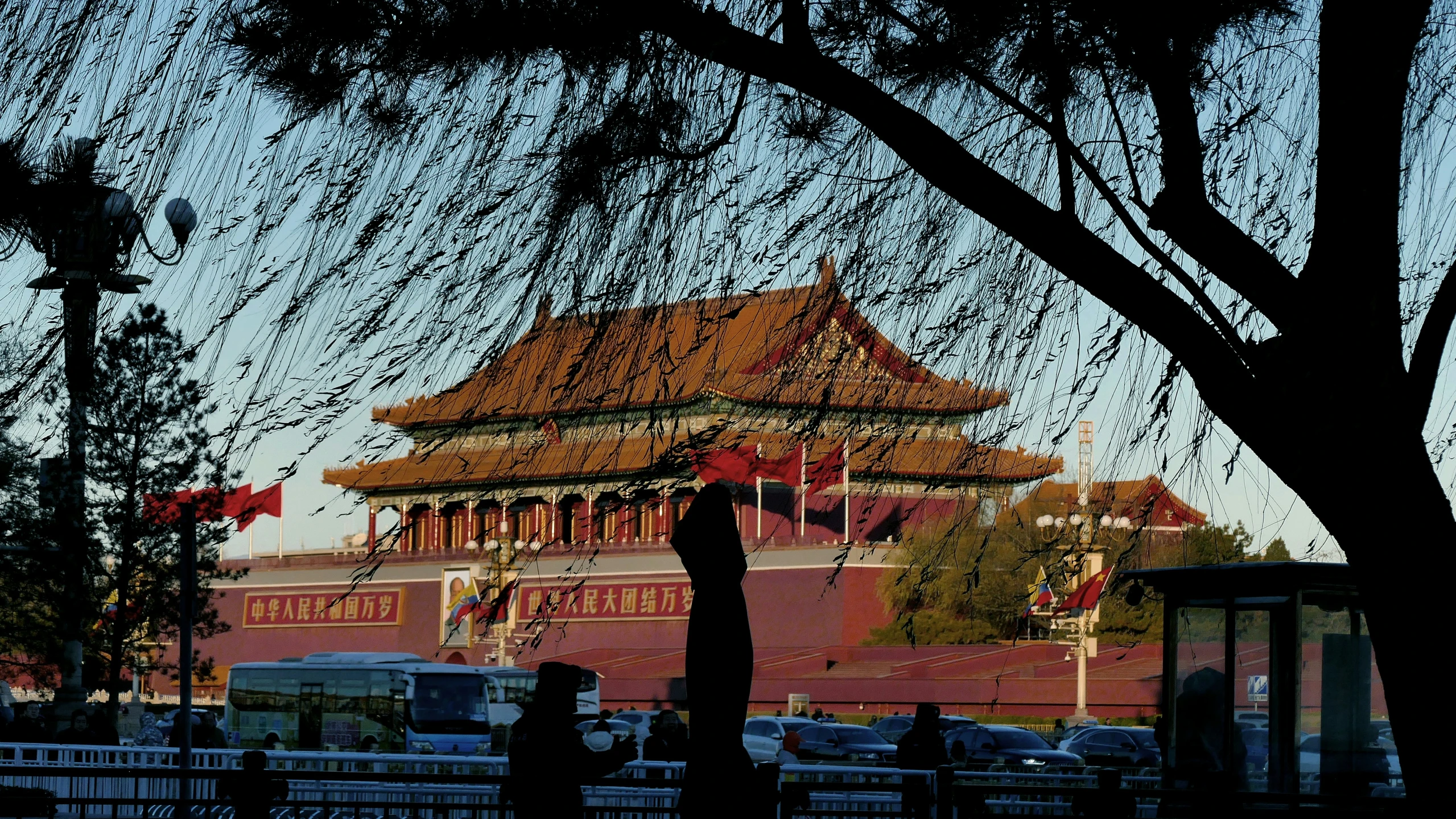 a temple with a few cars in the background