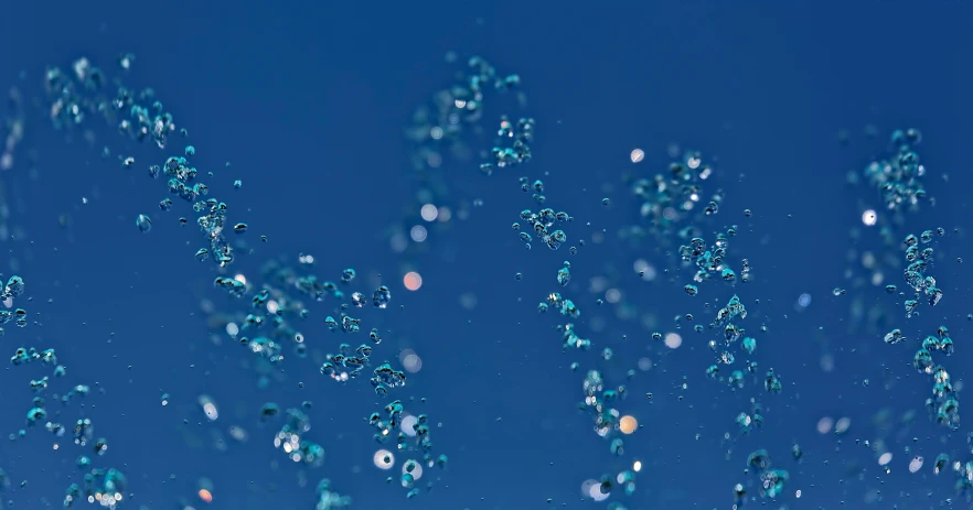 a blue sky with many bubbles in the air