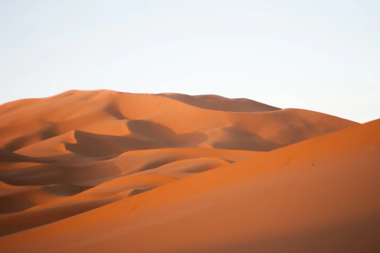 a large group of sand dunes in the distance