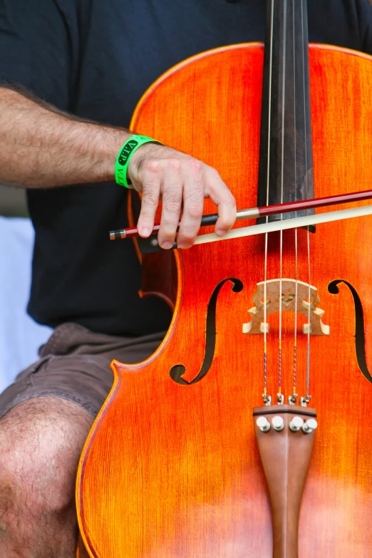 a man that is holding a cello