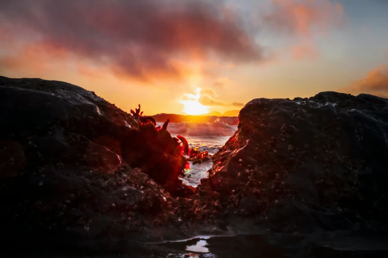 a small boat at the edge of a cliff and beach