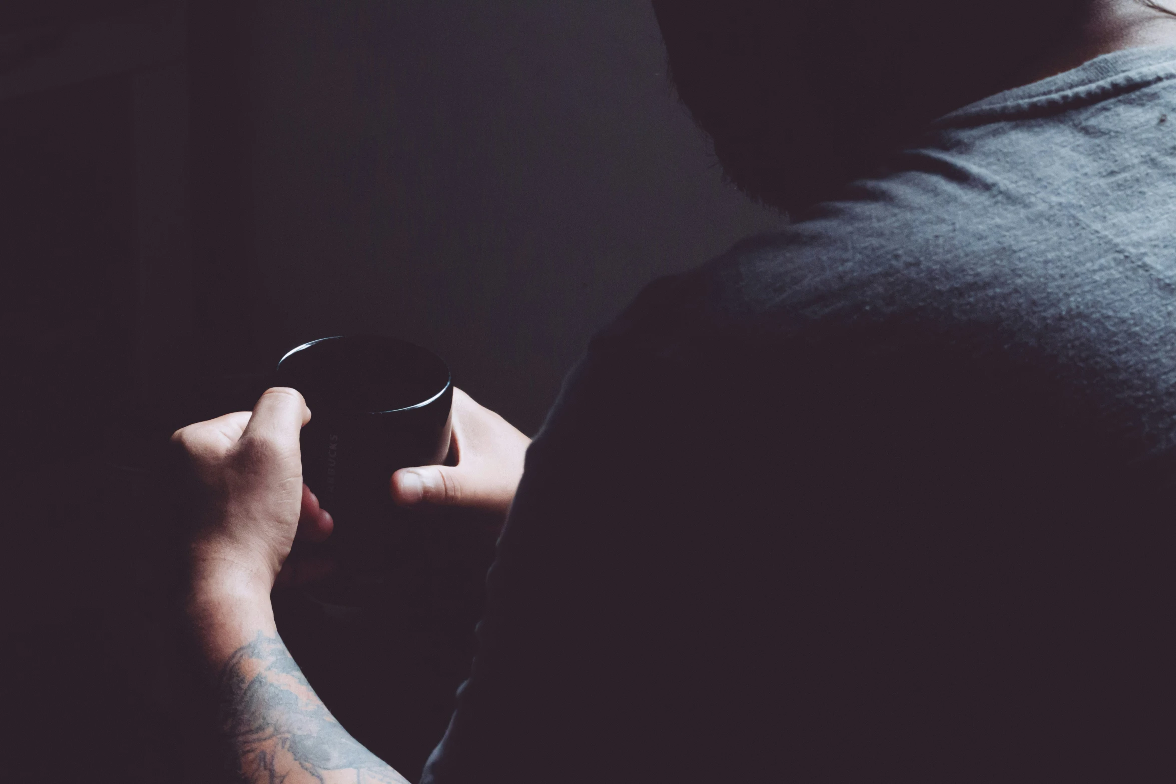 a man holding his cup with both hands