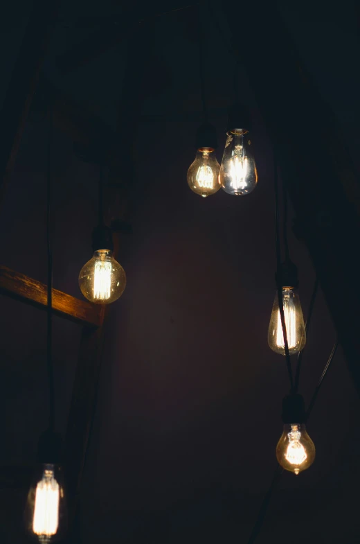 five light bulbs are hanging above the mirror