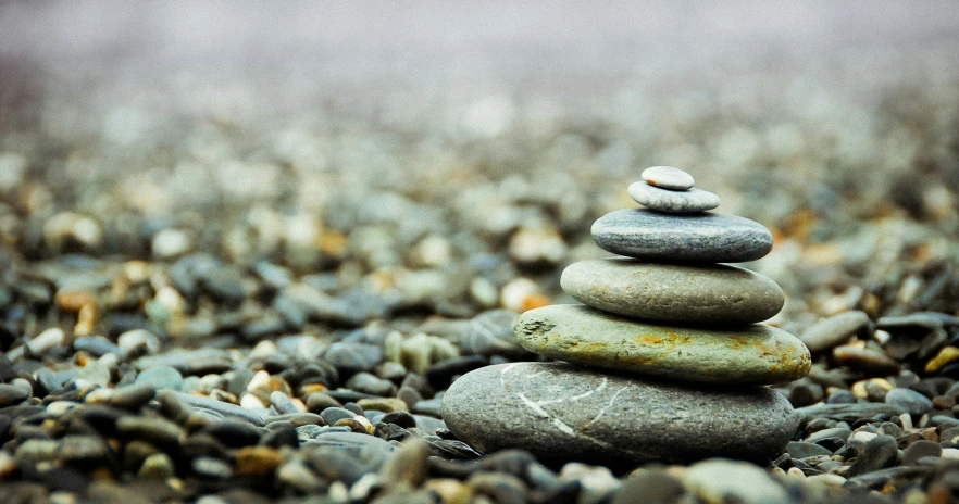 the stones are stacked together in the sand