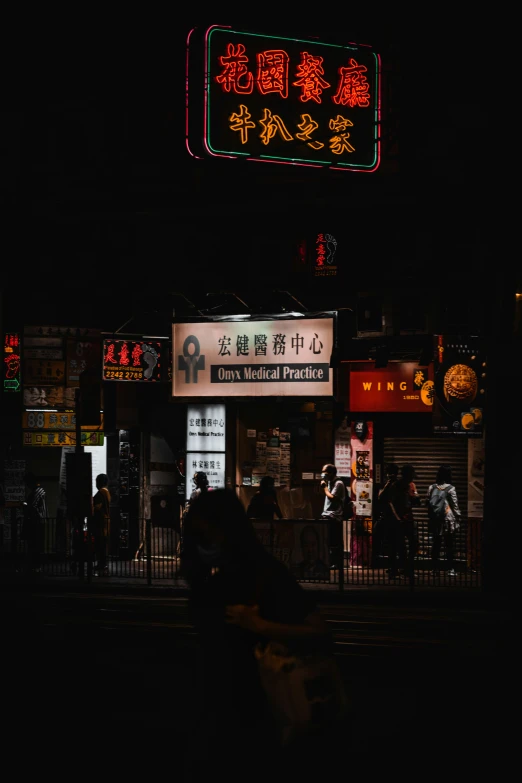 many people are walking near an asian restaurant