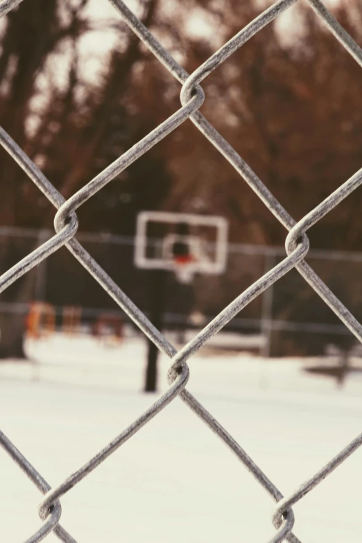 an outdoor basketball court with a chain link fence