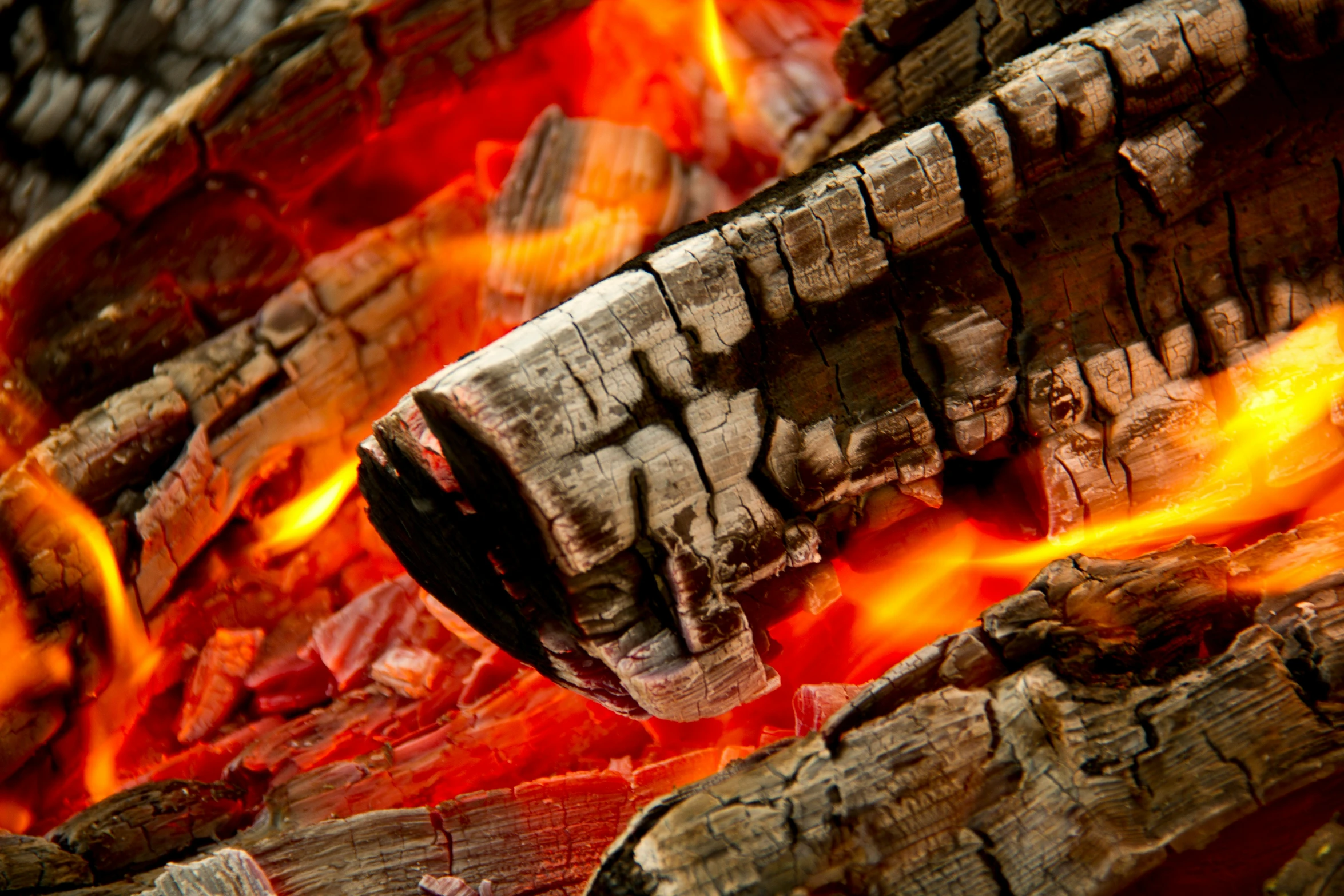 a close up of a fire with logs and flames