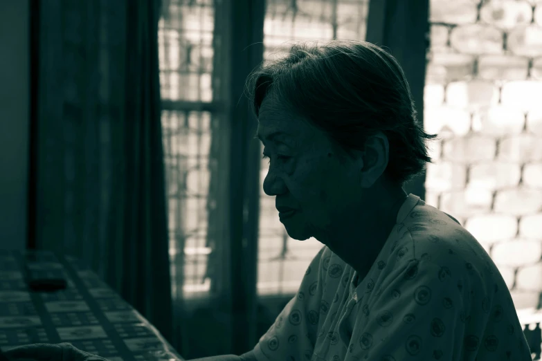 a woman that is sitting down with her hands on the counter