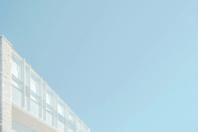 a clear blue sky and two tall white buildings