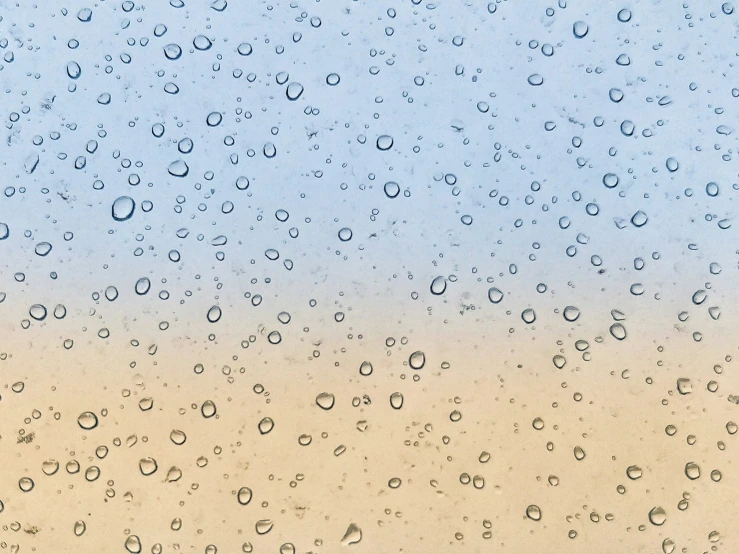 rain drops on the window and ground as seen from a window