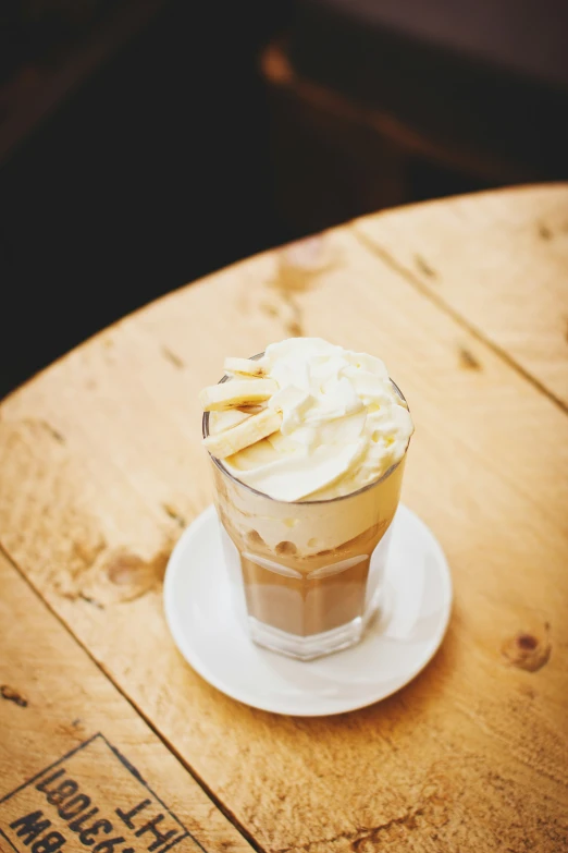 a dessert sits on a plate near an empty cup