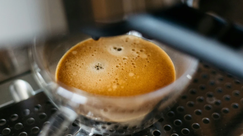 this espresso cup is filled with liquid and there is only one cap